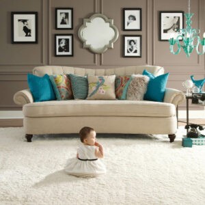 Cute baby sitting on carpet floor | Floor Coverings of Winona