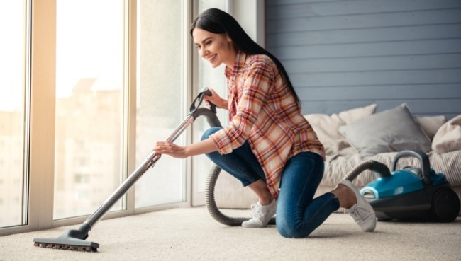 Lady cleaning carpet floor | Floor Coverings of Winona