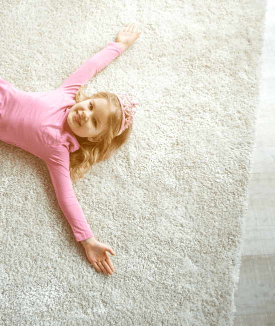 Cute girl laying on rug | Floor Coverings of Winona
